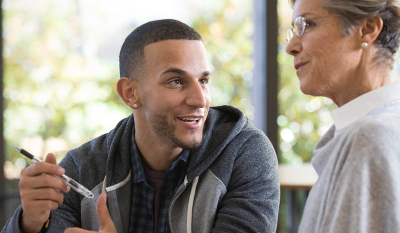 Man caring for older colleague